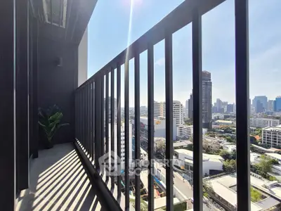 Stunning city view from a modern high-rise balcony with sleek railing design.