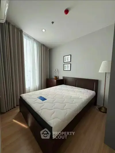 Spacious bedroom with modern furnishings and natural light