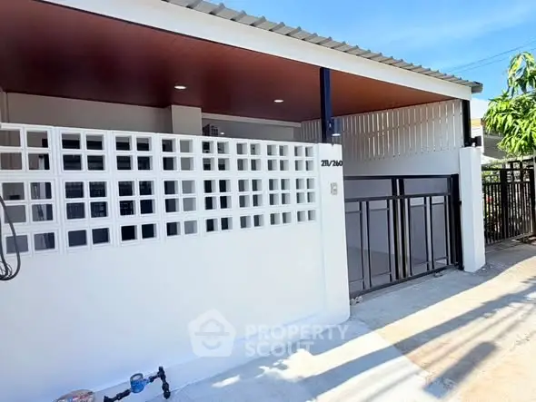 Modern single-story home with gated entrance and stylish facade.
