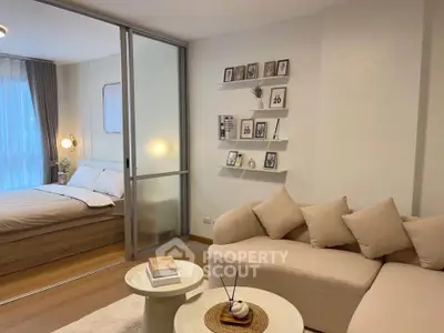 Modern cozy living room with elegant decor and adjacent bedroom view