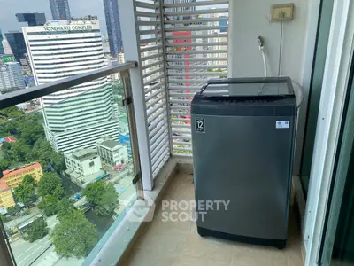 High-rise balcony with washing machine and city view, perfect for urban living.