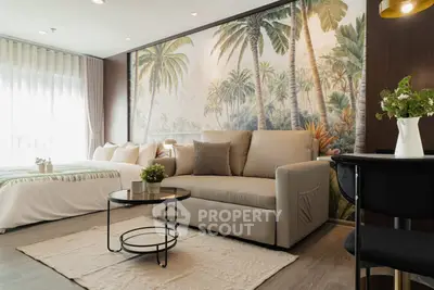 Stylish living room with tropical wallpaper and cozy beige sofa in modern apartment.