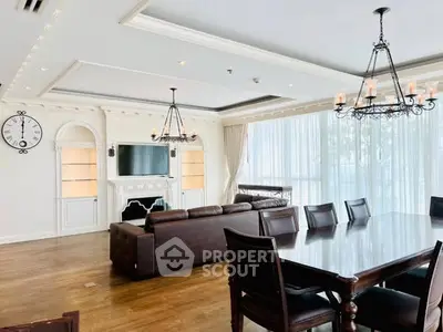 Luxurious living room with elegant chandelier and spacious dining area