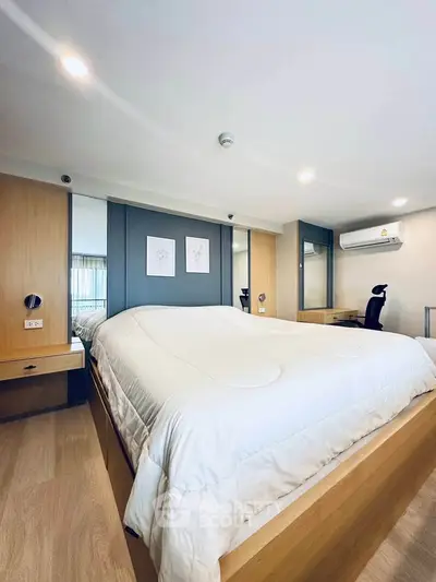 Modern bedroom with stylish decor and ample natural light