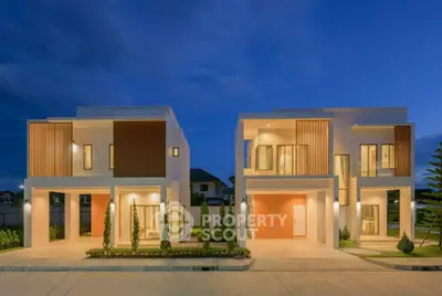 Modern two-story houses with elegant facade and ambient lighting at dusk.