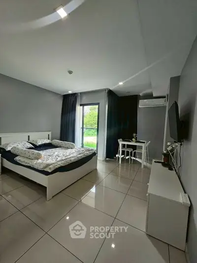 Modern bedroom with sleek design, featuring a cozy bed, stylish furniture, and a view of the garden.
