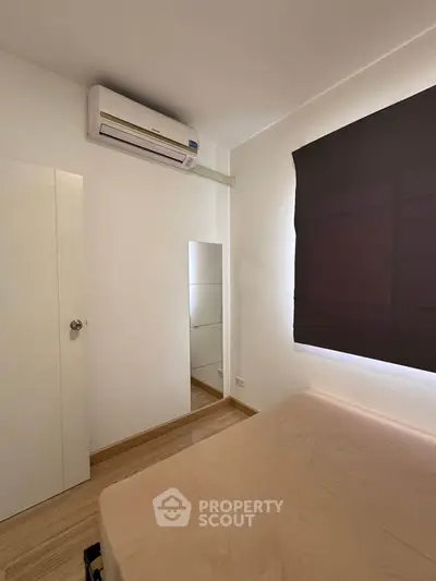 Cozy bedroom with air conditioning and minimalist decor, perfect for a peaceful retreat.