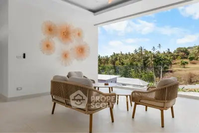 Modern living room with stylish furniture and stunning view of tropical landscape.