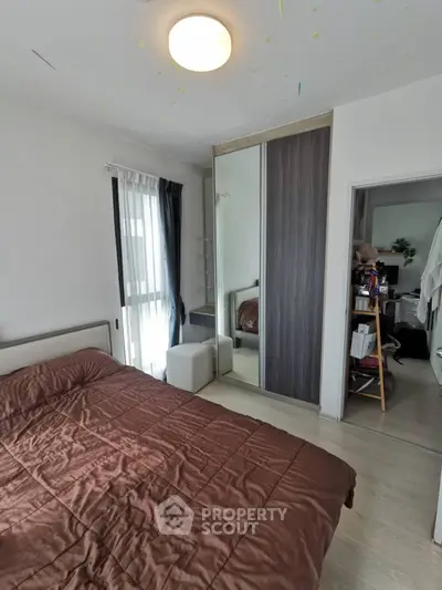 Cozy bedroom with modern wardrobe and natural light