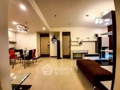 Spacious modern living room with stylish furniture and open dining area, perfect for entertaining.