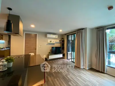 Modern living room with open kitchen and large windows in stylish apartment