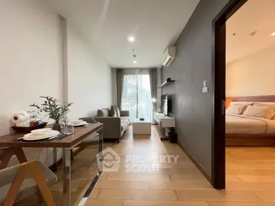 Modern apartment interior with cozy living room and elegant bedroom, featuring wooden flooring and stylish decor.