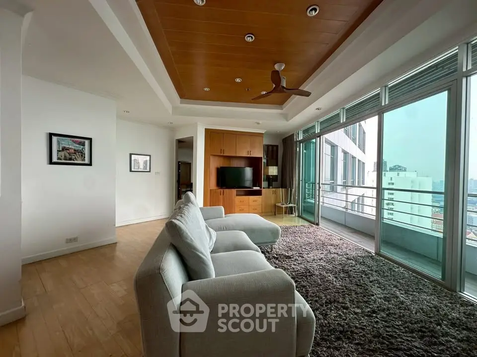 Spacious living room with modern decor and city view balcony