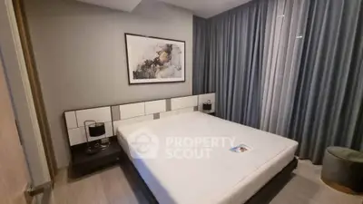 Modern bedroom with stylish decor and large bed in a cozy apartment.