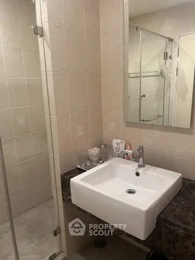 Modern bathroom with sleek sink and glass shower enclosure