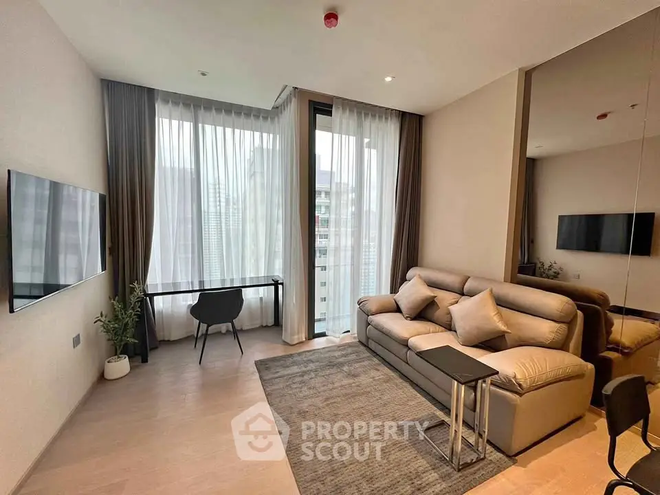 Modern living room with sleek furniture and large windows offering city views.