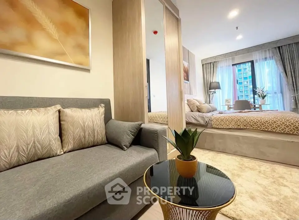 Modern studio apartment with cozy living area and stylish bedroom