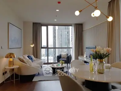 Modern living room with elegant decor and city view, featuring stylish furniture and ambient lighting.