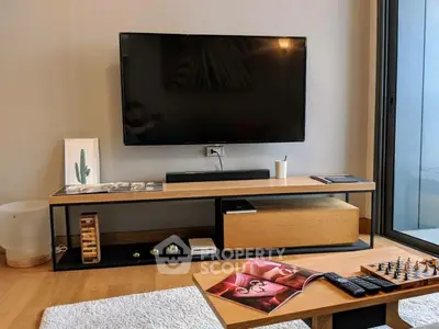 Modern living room with sleek TV setup and stylish wooden furniture, perfect for contemporary living.