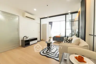 Modern open-layout living room with stylish decor and natural light