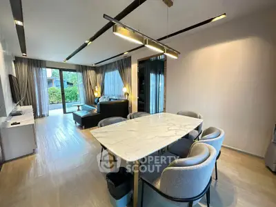 Spacious modern living and dining area with elegant furnishings and natural light.