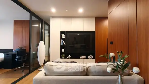 Modern living room with sleek design and cozy ambiance, featuring a stylish sofa and elegant decor.