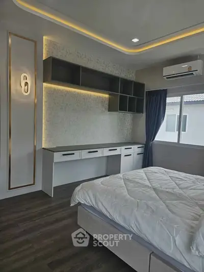 Modern bedroom with stylish ceiling lights and built-in storage, featuring a cozy bed and large window.