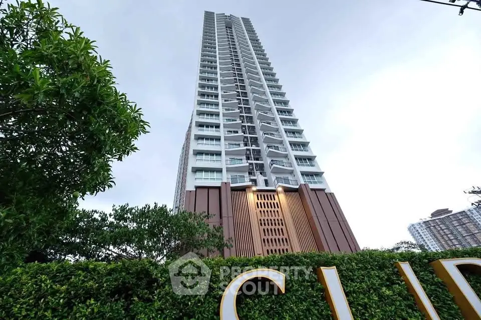 Stunning high-rise building with modern architecture and lush greenery, perfect for urban living.