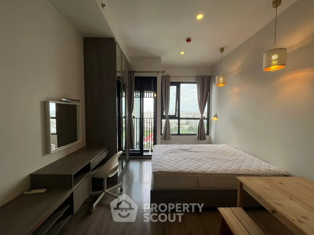 Modern bedroom with city view and stylish lighting in high-rise apartment