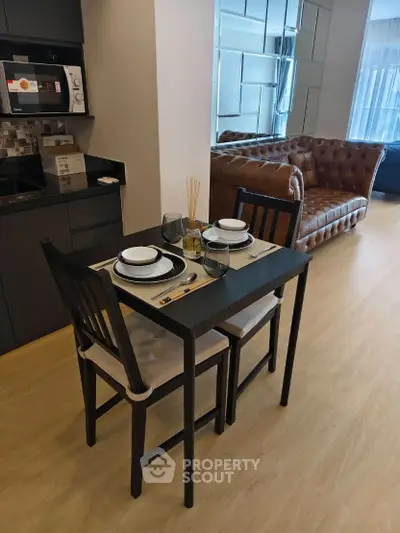 Modern open-plan living room with stylish dining area and leather sofa, perfect for urban living.
