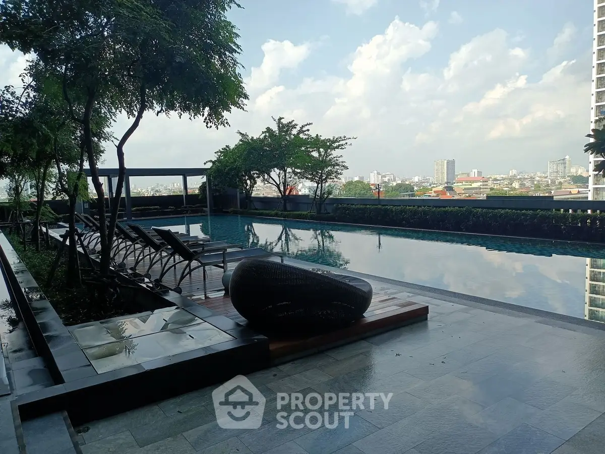 Luxurious rooftop pool with stunning city view and modern lounge chairs