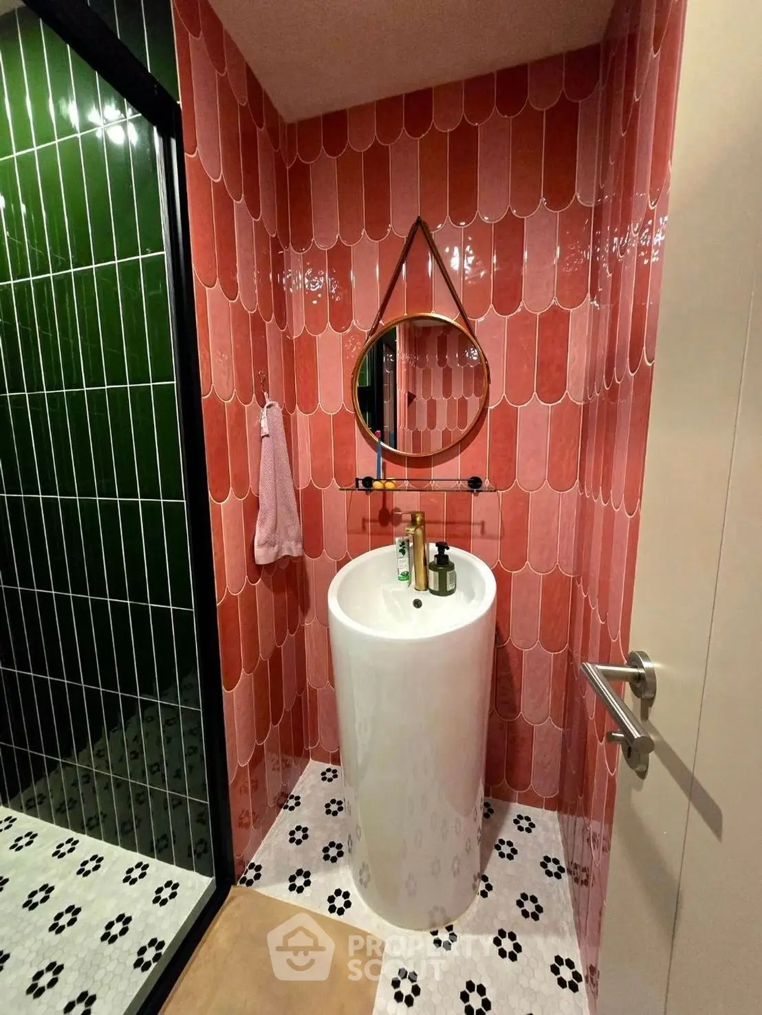 Stylish bathroom with modern pink tiles and sleek pedestal sink