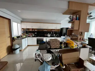 Spacious kitchen with modern appliances and ample storage in a contemporary home.