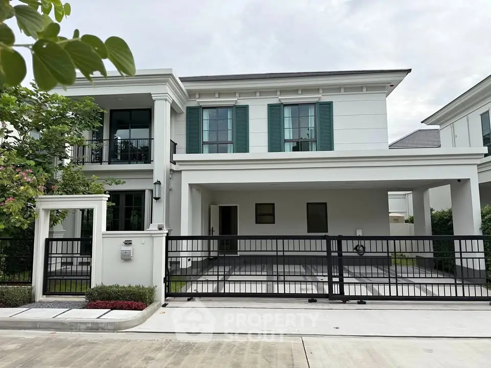 Elegant modern house with green shutters and spacious driveway in a serene neighborhood.