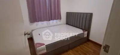 Cozy bedroom with modern bed and wooden flooring, perfect for restful nights.