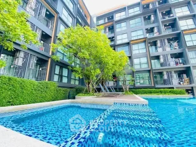 Modern apartment building with a stunning pool and lush greenery