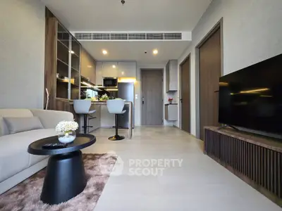 Modern living room with open kitchen and stylish decor