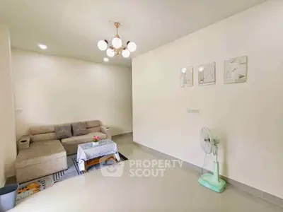Spacious living room with modern sofa and elegant lighting in a cozy apartment.