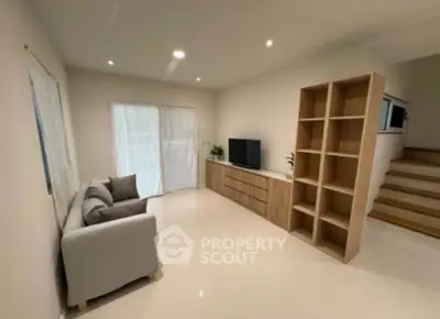 Modern living room with sleek furniture and natural light, perfect for relaxation and entertainment.