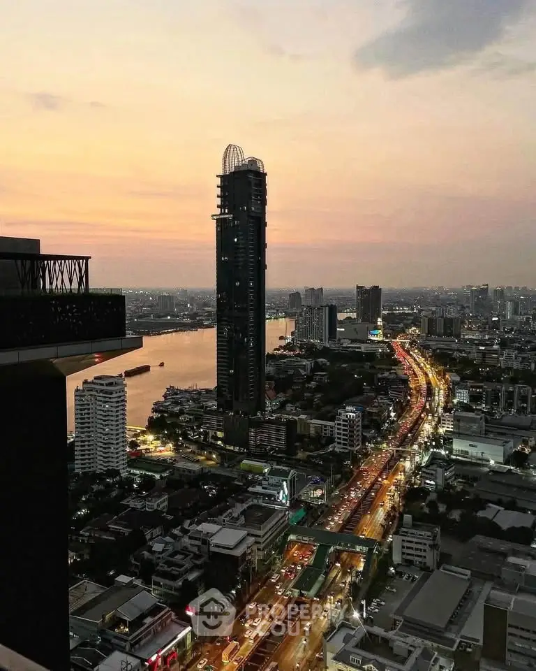 Stunning cityscape view from high-rise building at sunset, showcasing vibrant urban life and river scenery.