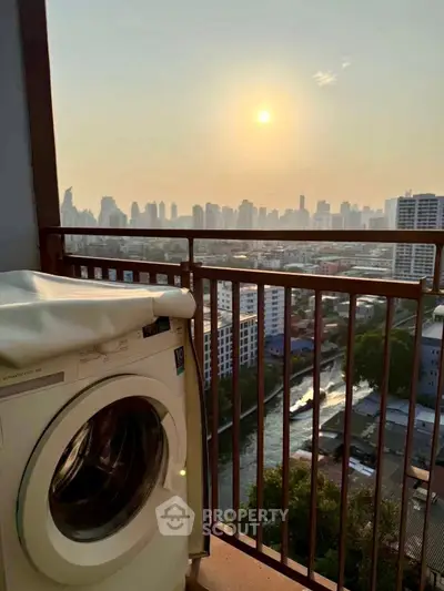 Stunning city view from high-rise balcony with washing machine, perfect for urban living.