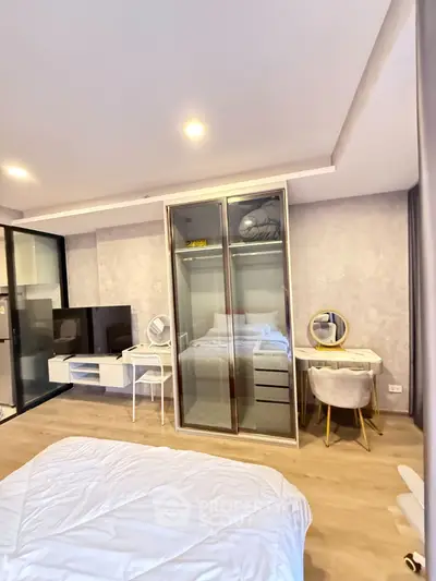 Modern bedroom with stylish decor and mirrored wardrobe in a cozy apartment.