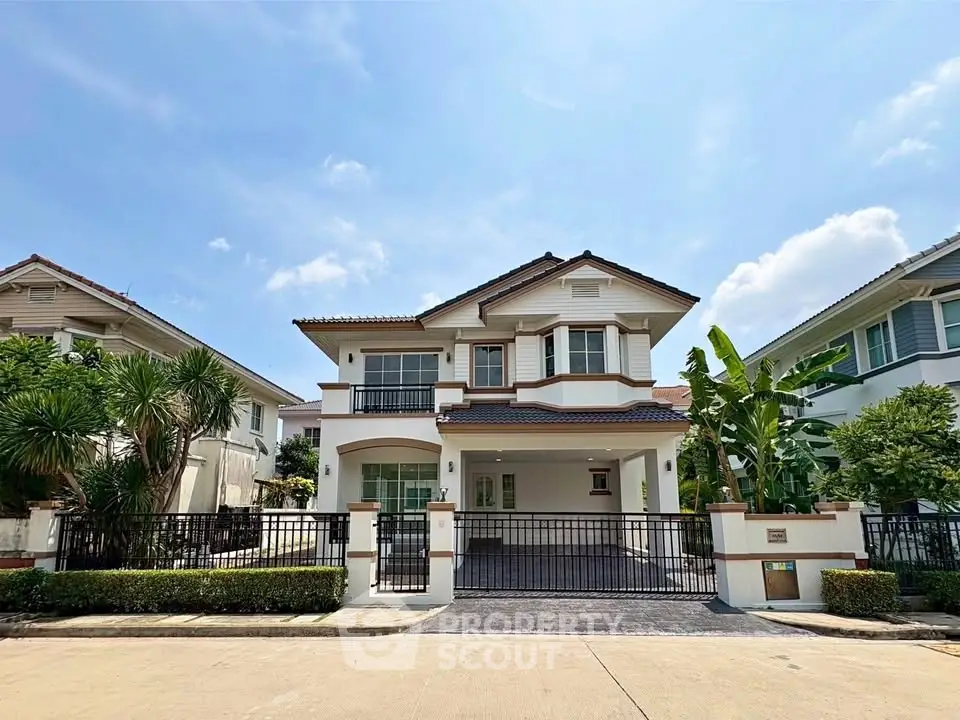 Stunning two-story house with elegant facade and lush greenery in a serene neighborhood.