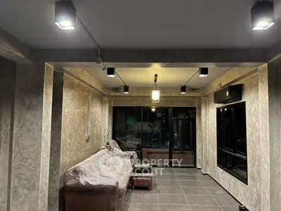 Spacious modern living room with stylish lighting and large windows