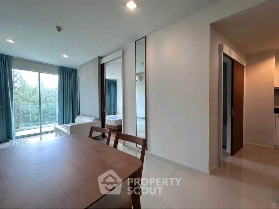 Modern apartment interior with dining area and balcony view
