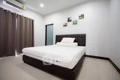 Modern bedroom with minimalist decor and large bed in a stylish apartment.