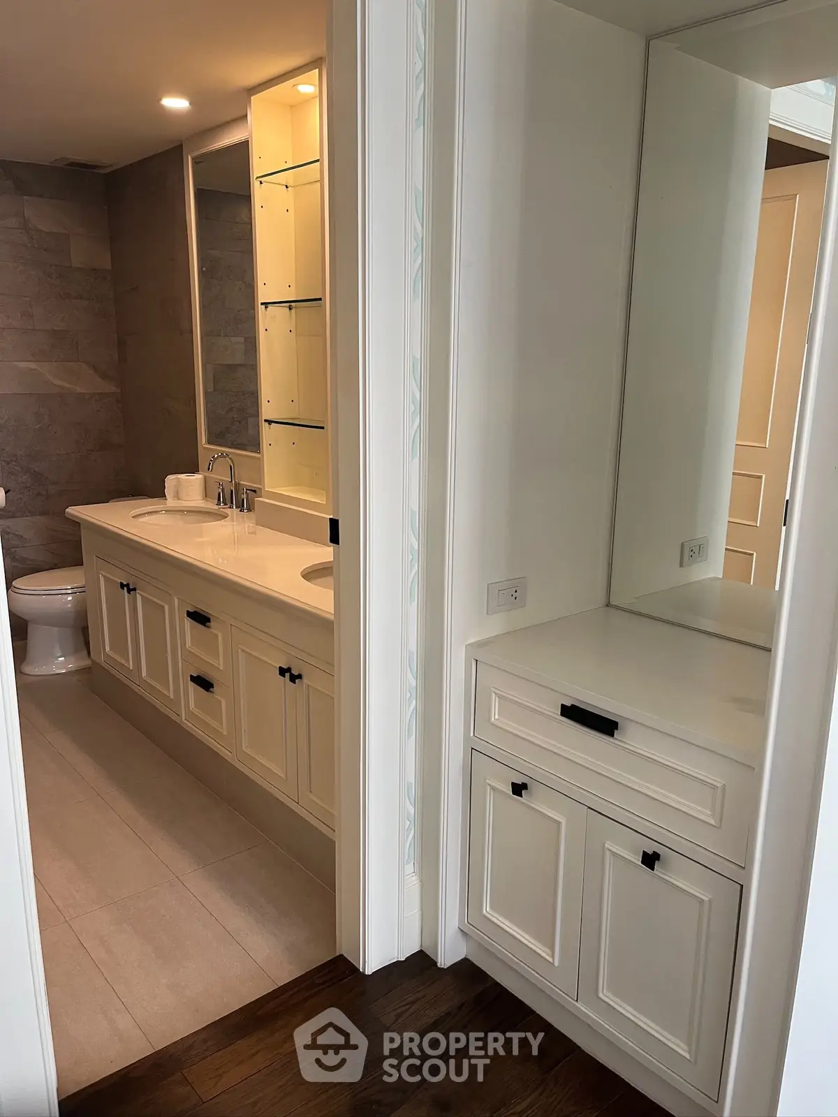 Elegant bathroom with dual sinks and modern cabinetry in a luxury home.