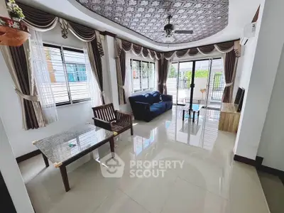 Spacious living room with elegant decor and large windows for natural light.