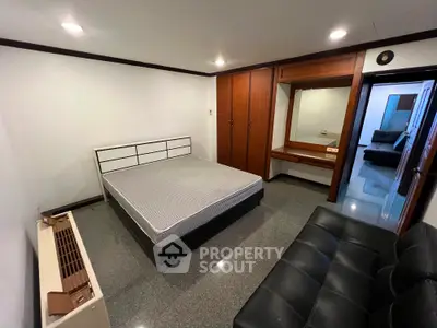 Spacious bedroom with modern furniture and sleek design