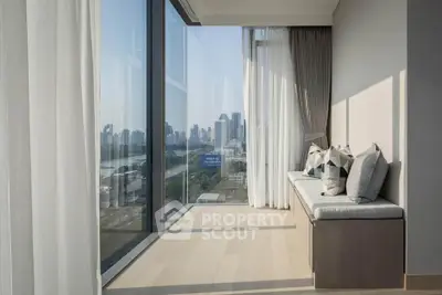 Luxurious corner unit with floor-to-ceiling windows offering a stunning city view, featuring elegant seating area.